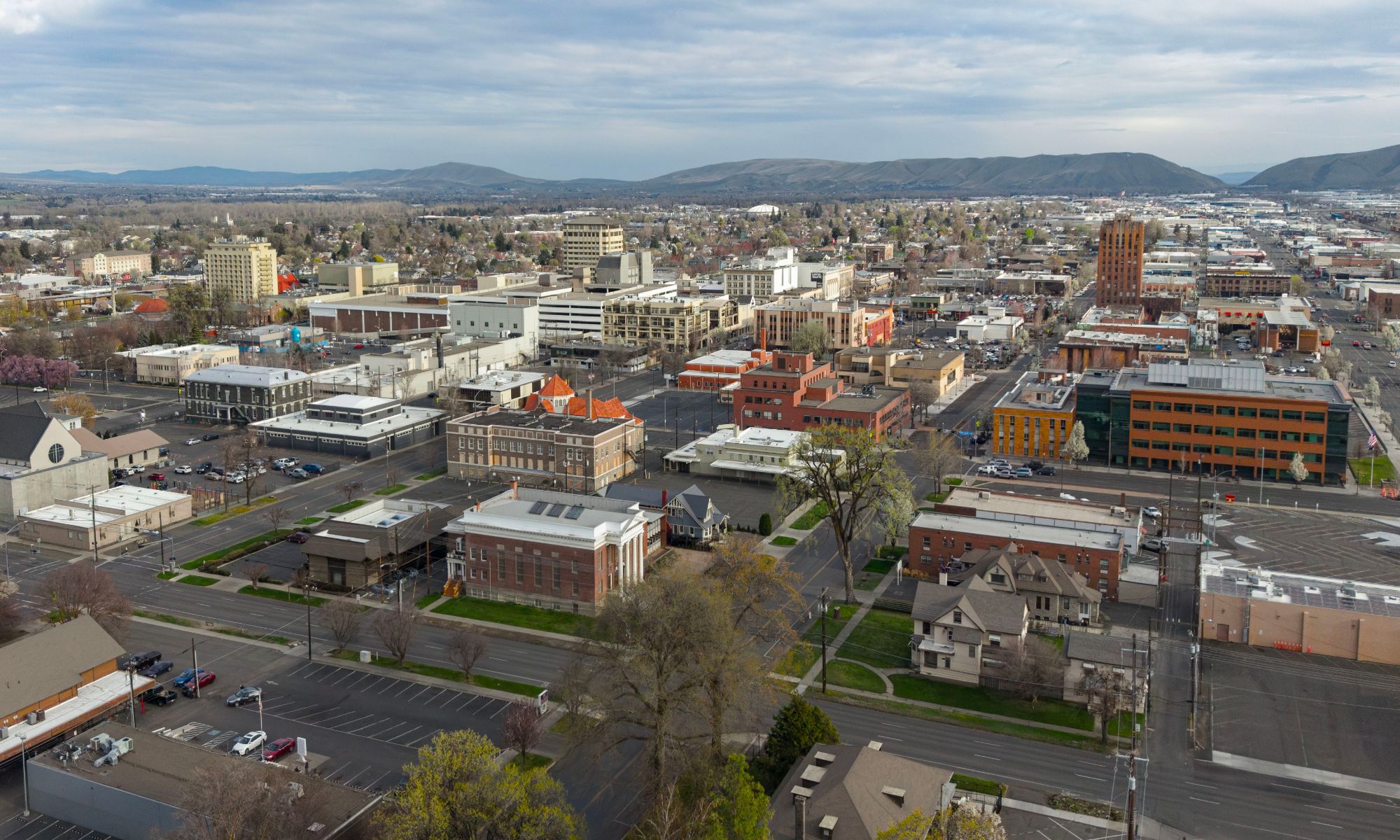 Aerial view of downtown Yakima with the hills behind it